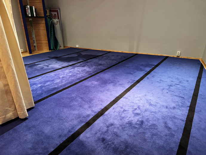 Room with a blue prayer rug.